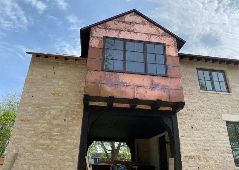 Copper metal panel facade on a stone building for Roof Repair in Mascoutah