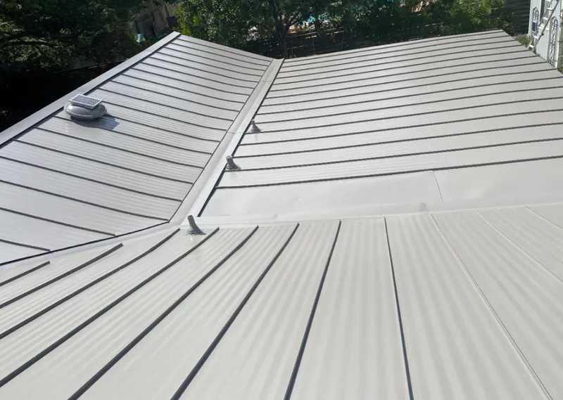 Solar attic fan installed on a metal roof for Roof Ventilation in Mascoutah